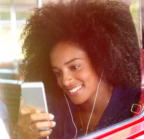 Girl with headphones streaming movies and TV on mobile phone on public transport - Optus Girl with headphones streaming movies and TV on mobile phone on public transport - Optus
